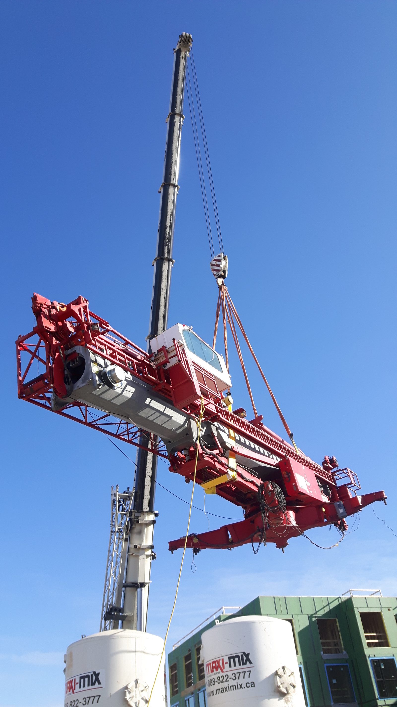 Self-erecting tower crane being lifted into place on an Ontario job site